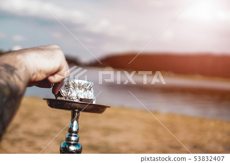 Hookah bowl stands in nature by the river close up Hookah bowl stands in nature by the river close up 53832407
