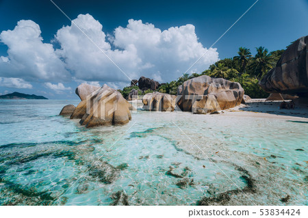 Impressive cloudscape above Anse Source D'Argent tropical beach, La Digue Seychelles. Luxury exotic 53834424