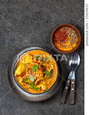 INDIAN FOOD. Traditional KERALA FISH CURRY with naan bread, gray plate, black background  53834655