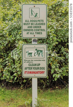 Two signs reminding pet owners to have a leash and 53835078