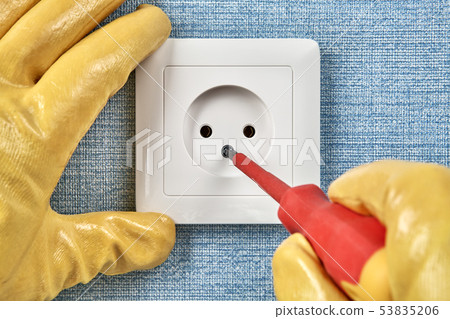 Worker in yellow protective gloves installs Worker in yellow protective gloves installs 53835206