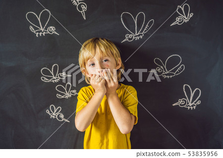 The boy is bitten by mosquitoes on a dark background. On the blackboard with chalk painted The boy is bitten by mosquitoes on a dark background. On the blackboard with chalk painted 53835956