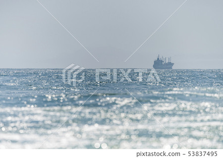 Sea ship sails. Along the shore at sun light Sea ship sails. Along the shore at sun light 53837495