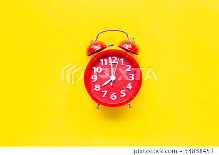 Red alarm clock ring on yellow background. Red alarm clock ring on yellow background. 53838451