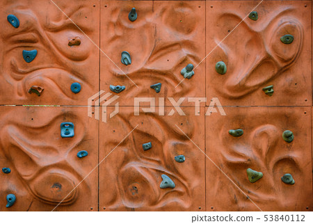 Climb wall. Holds for rock climbing on a wall in the gym. Climb wall. Holds for rock climbing on a wall in the gym. 53840112