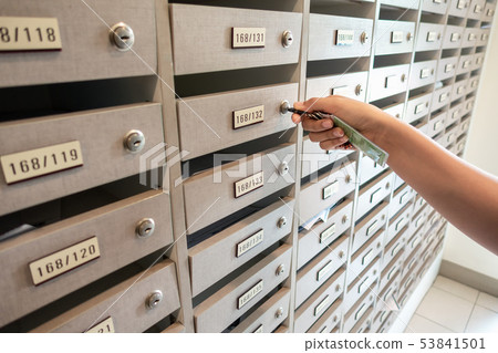 Close-Up Woman Hand Insert a Key to Unlock Mailbox Close-Up Woman Hand Insert a Key to Unlock Mailbox 53841501
