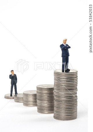 Miniature business man with coin tower Miniature business man with coin tower 53842033