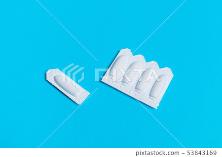 suppository on a blue background.hemorrhoids, 53843169