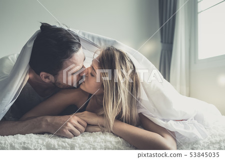 Loving happy couple in love smile and kiss each Loving happy couple in love smile and kiss each 53845035