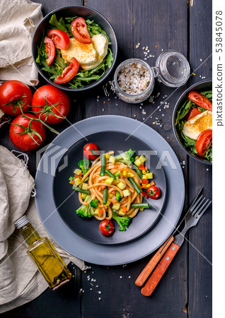 Pasta with vegetables and salad with arugula Pasta with vegetables and salad with arugula 53845078