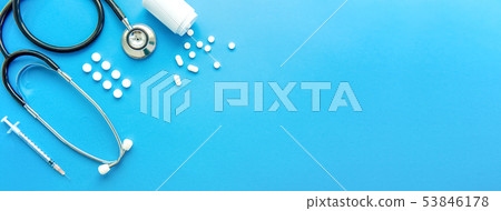 Pills and medical equipment on light blue banner  53846178