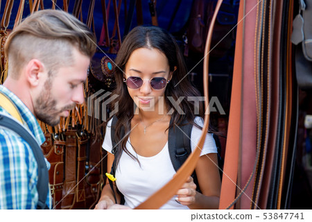 Couple tourists looking at leather products Couple tourists looking at leather products 53847741