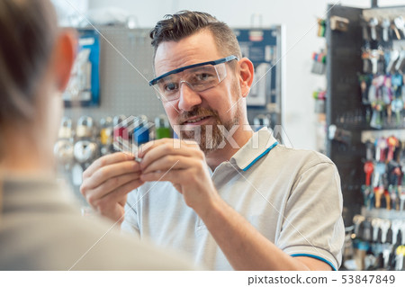 Locksmith showing woman key blanks 53847849