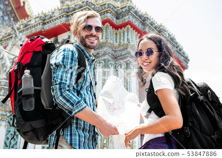 Tourist backpackers traveling ancient Thai temple 53847886