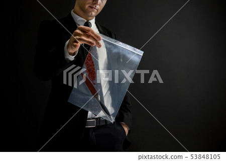 Officer showing a knife with blood as an evidence Officer showing a knife with blood as an evidence 53848105