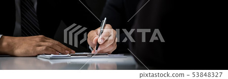 Businessman signing contract at the table 53848327