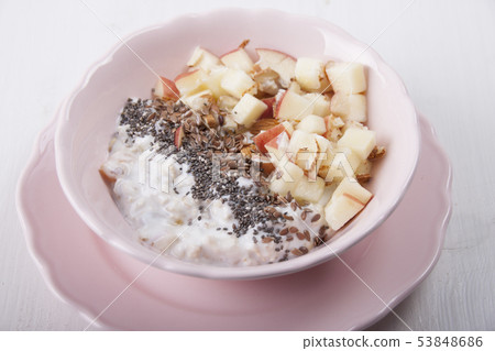 Homemade muesli with nuts and apples in a pink 53848686