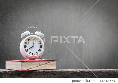 Back to school education concept clock on book 53848775