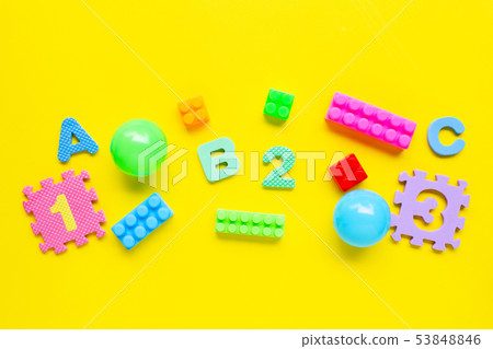Colorful Kids toys on yellow background. 53848846