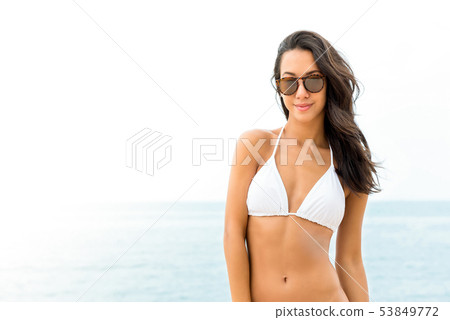 Young beautiful Asian woman in white swimsuit 53849772