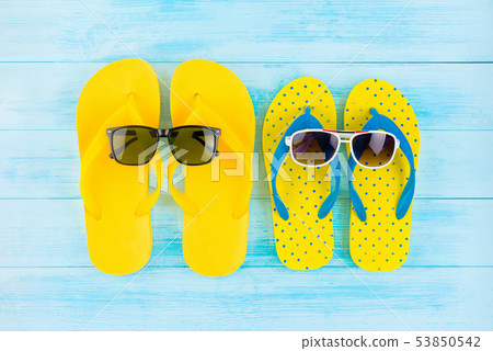 Colourful yellow flip flops with sunglasses Colourful yellow flip flops with sunglasses 53850542
