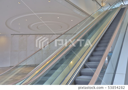 the Metal stairs of an empty escalator. 53854282