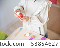 Infant playing with the rest 53854627