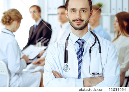 Doctor smiling against of group of patients and nurse. Best treatment and service in medicine 53855964
