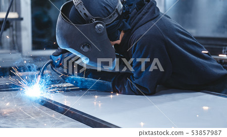 Welders On A Mission. Industrial labourer welding steel structure 53857987
