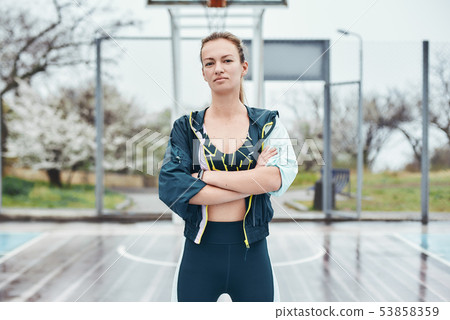 Beautiful and strong. Confident young disabled woman in sport wear keeping arms crossed while Beautiful and strong. Confident young disabled woman in sport wear keeping arms crossed while 53858359