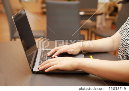 Female hand doing PC input in cafe 53858749