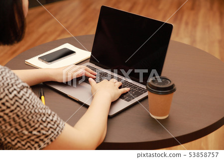 Female hands, smartphone and notebook doing PC input in cafe Female hands, smartphone and notebook doing PC input in cafe 53858757