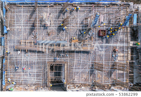Aerial view of busy industrial construction site 53862299