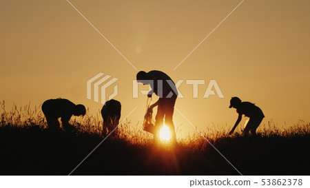 A group of volunteers picks up trash in nature. Clean environment concept 53862378