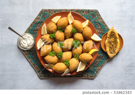 Traditional Arabic kibbeh with lamb and pine nuts Traditional Arabic kibbeh with lamb and pine nuts 53862383