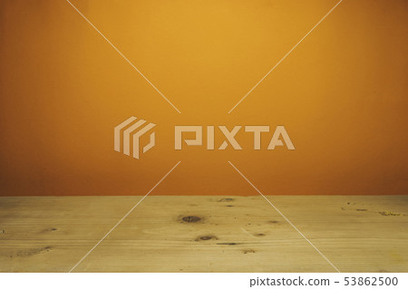 Beautiful white wooden table and orange wall Beautiful white wooden table and orange wall 53862500
