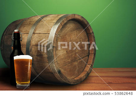 Wooden barrel, glass of beer and black bottle on a Wooden barrel, glass of beer and black bottle on a 53862648