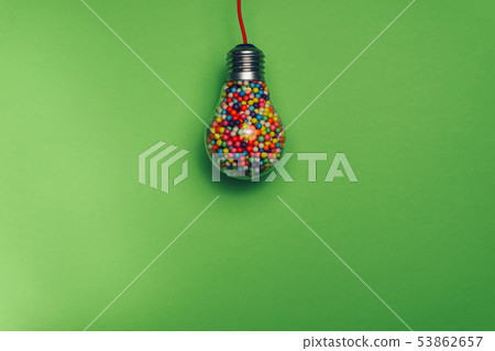 Lightbulb filled with multi colored ball on a 53862657