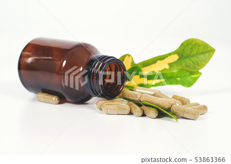 Alternative herb capsule spill out of bottle 53863366