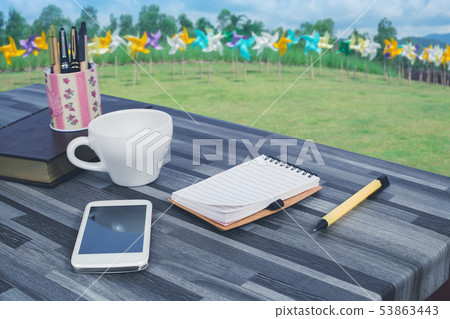 book note ,smart phone on office table with nature 53863443