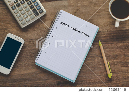 Action 2019 Plan text on book note with cup of Action 2019 Plan text on book note with cup of 53863446
