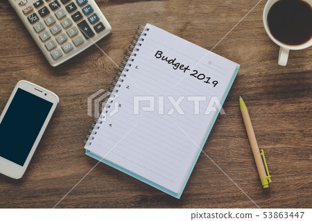 Budget 2019 Plan text on book note with cup of Budget 2019 Plan text on book note with cup of 53863447