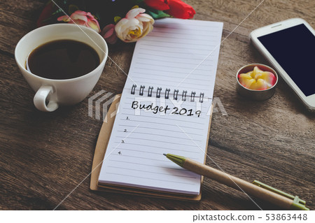 Budget 2019 Plan text on book note with cup of Budget 2019 Plan text on book note with cup of 53863448