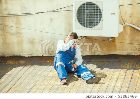 HVAC technician working on a capacitor part for condensing unit HVAC technician working on a capacitor part for condensing unit 53863469