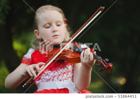 happy girl plays violin in summer park happy girl plays violin in summer park 53864451