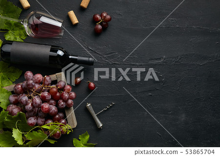 Top view of tasty fruit plate with the wine bottle on the black stone Top view of tasty fruit plate with the wine bottle on the black stone 53865704