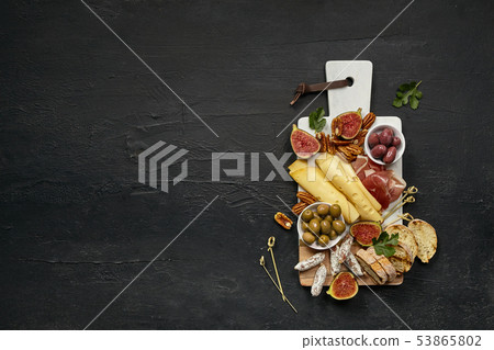 Top view of tasty cheese plate with the fruit on the black stone Top view of tasty cheese plate with the fruit on the black stone 53865802