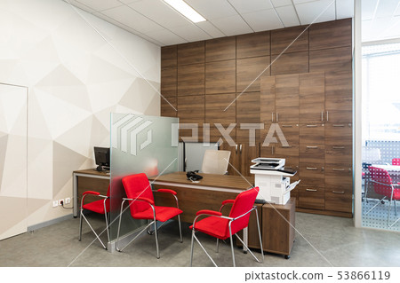 Minsk, Belarus - May 23, 2019: Corner of modern office with white and wooden walls, gray floor, open Minsk, Belarus - May 23, 2019: Corner of modern office with white and wooden walls, gray floor, open 53866119