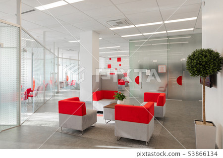 Minsk, Belarus - May 23, 2019: Corner of modern office with white walls, gray floor, open space area 53866134