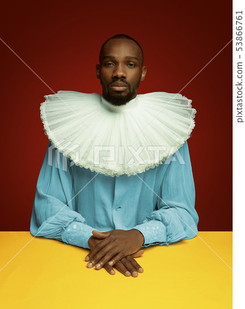 Young man as a medieval grandee on red background Young man as a medieval grandee on red background 53866761